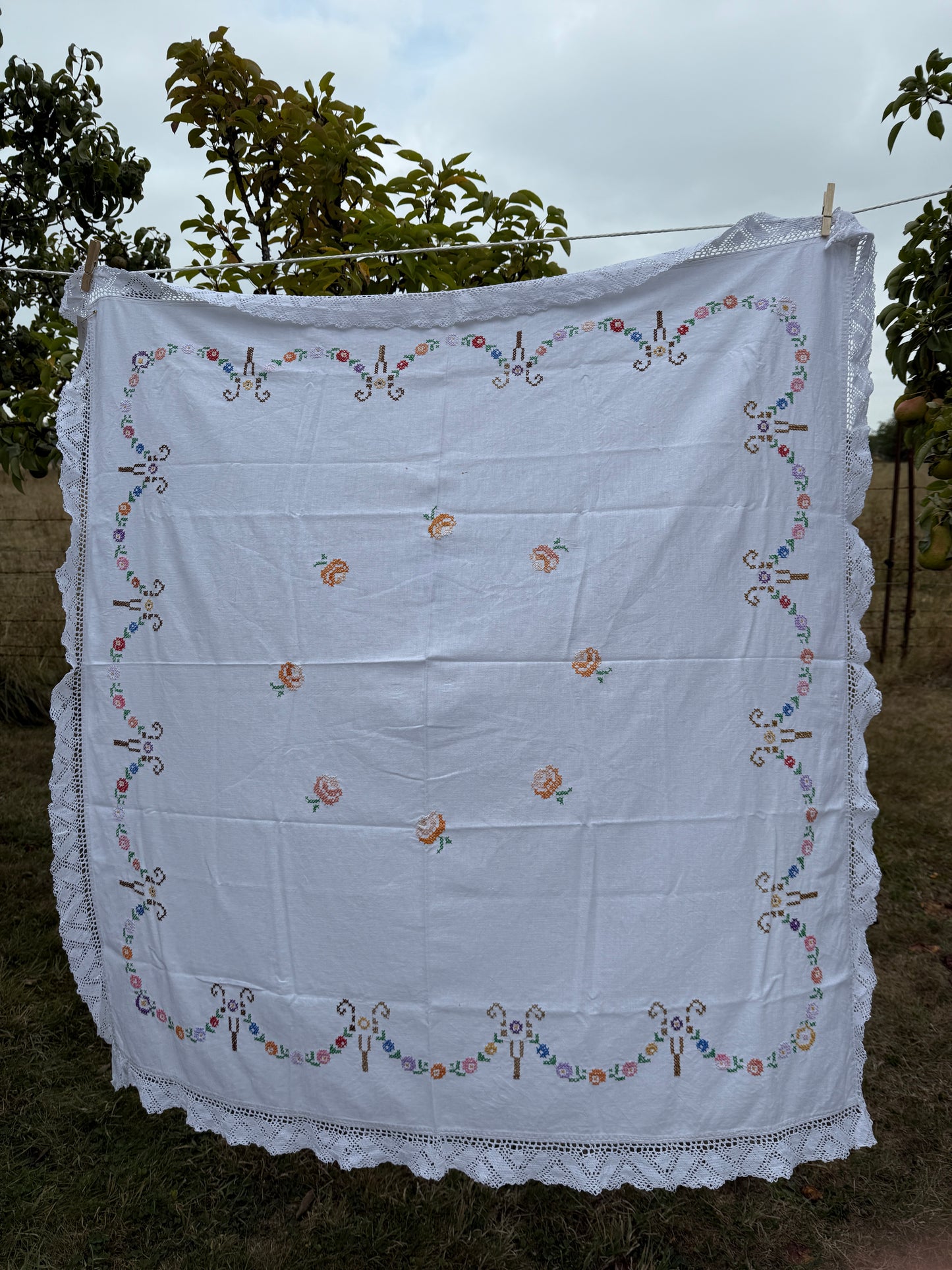 AA.multi colored cross stitch with crochet trim 47"x47"