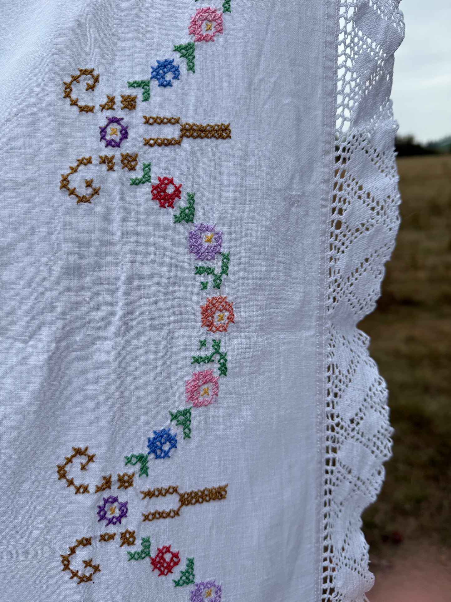 AA.multi colored cross stitch with crochet trim 47"x47"