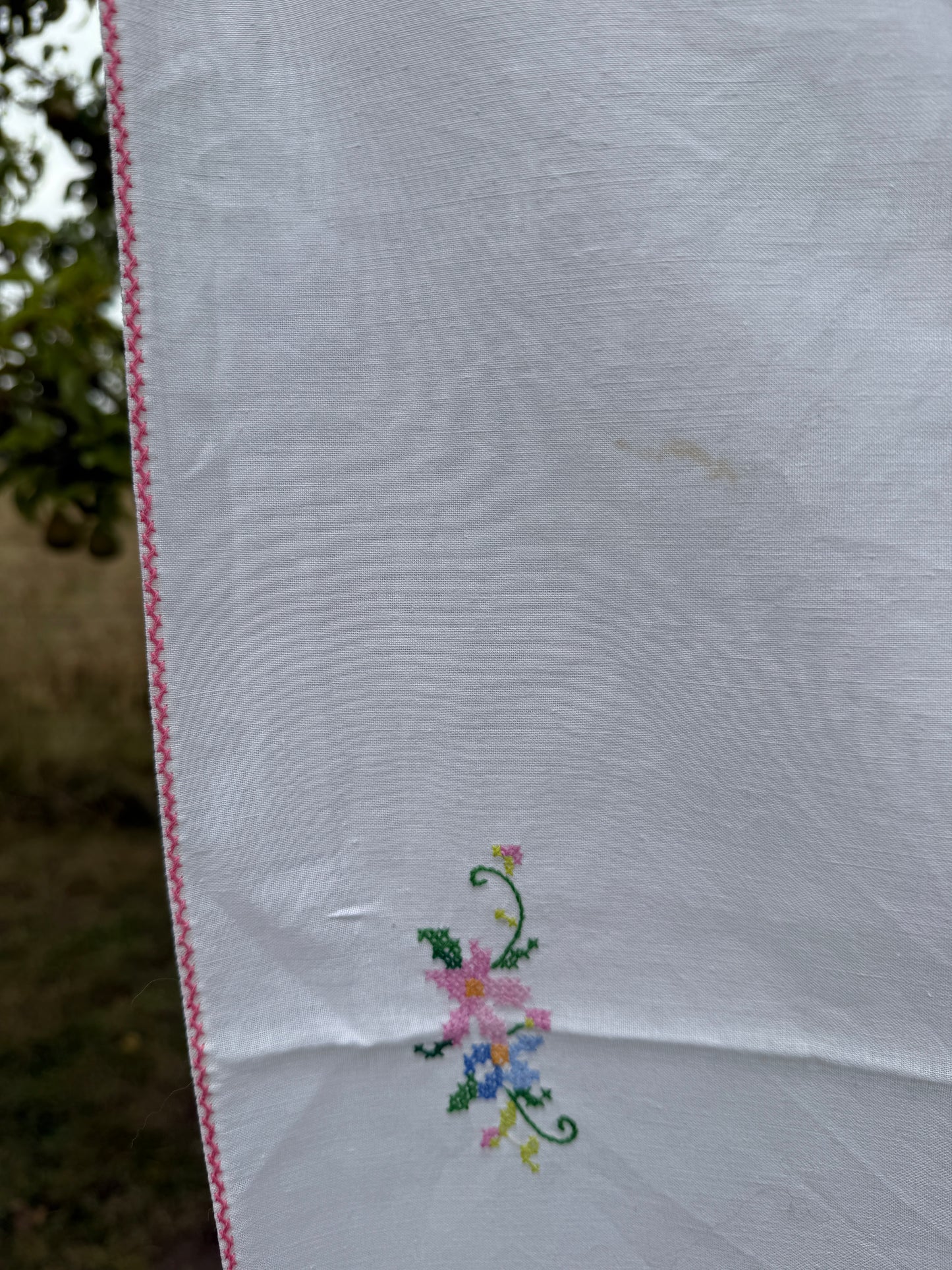 AA.Multi color cross stitch with pink edging 32" x 32"