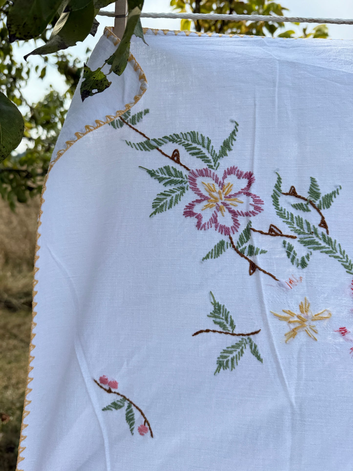 AA. multi colored flowers with yellow blanket stitch 58" x 44"