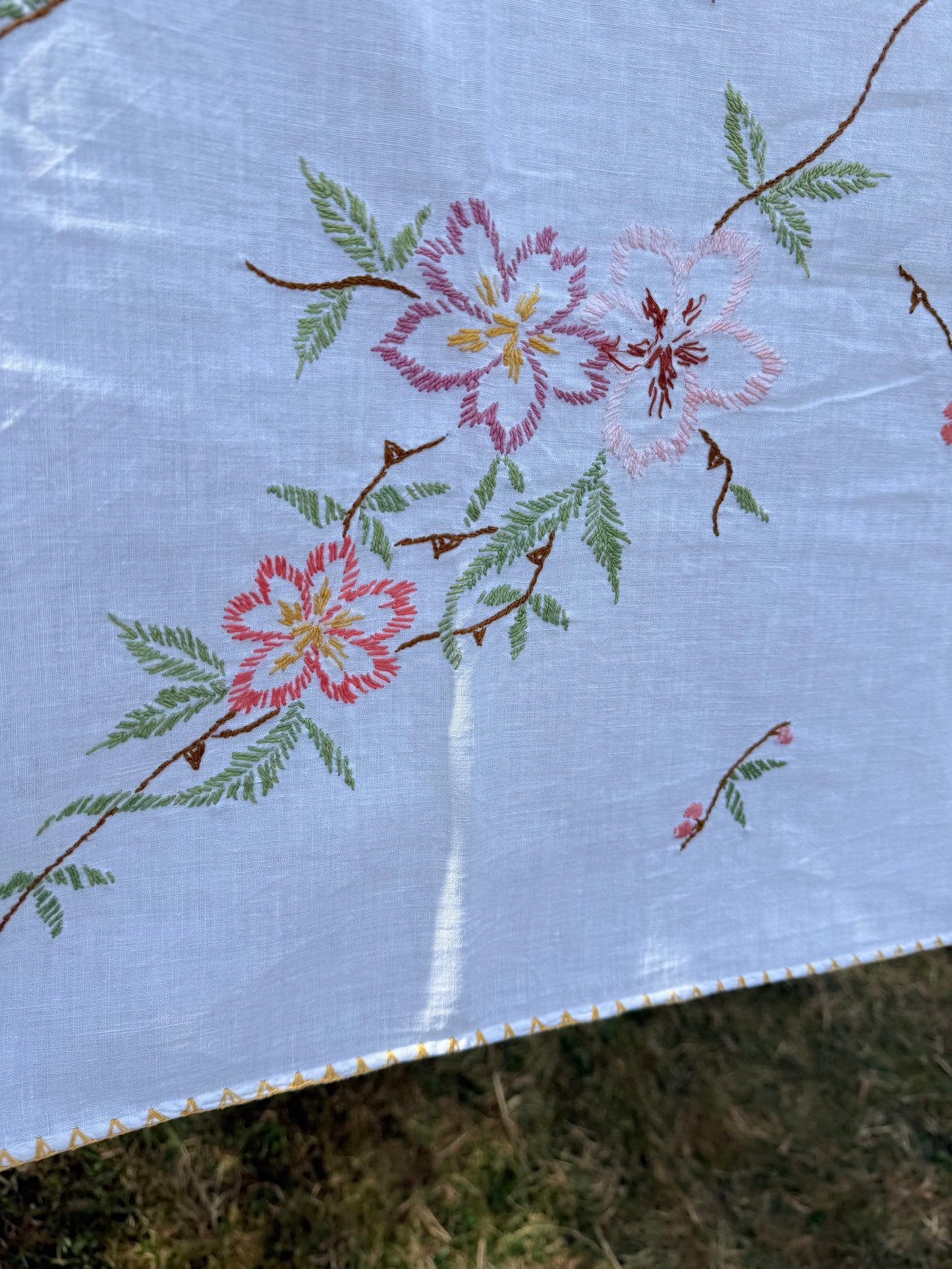 AA. multi colored flowers with yellow blanket stitch 58" x 44"