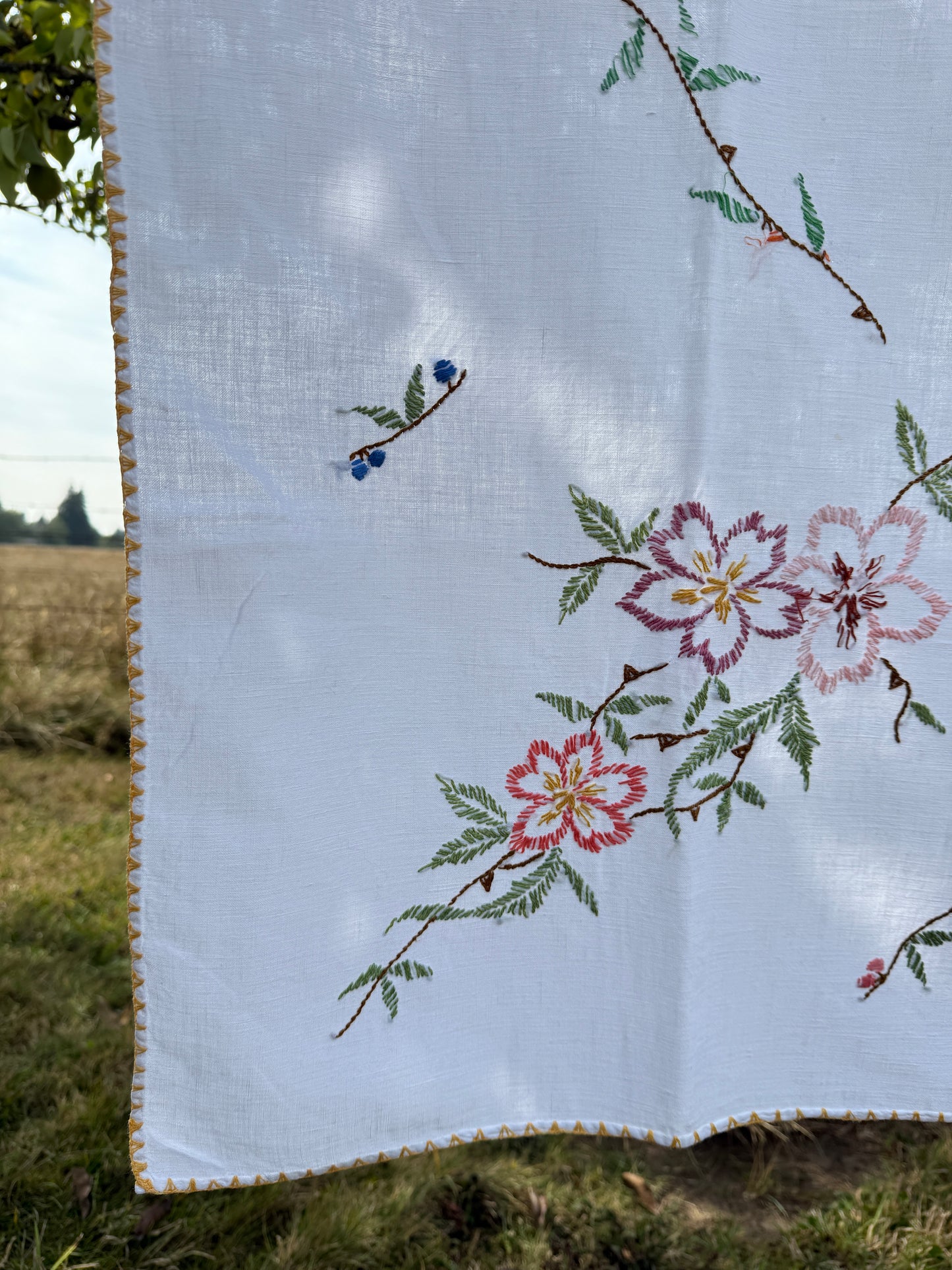 AA. multi colored flowers with yellow blanket stitch 58" x 44"