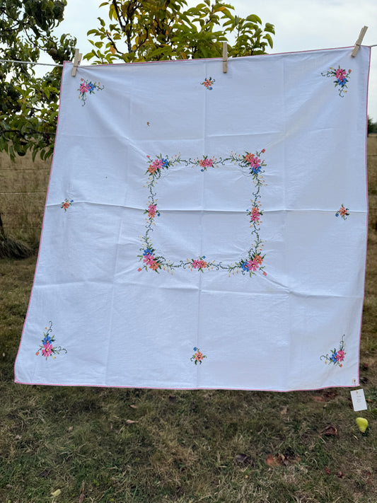 AA. white multi colored cross stitch 32" x 32"