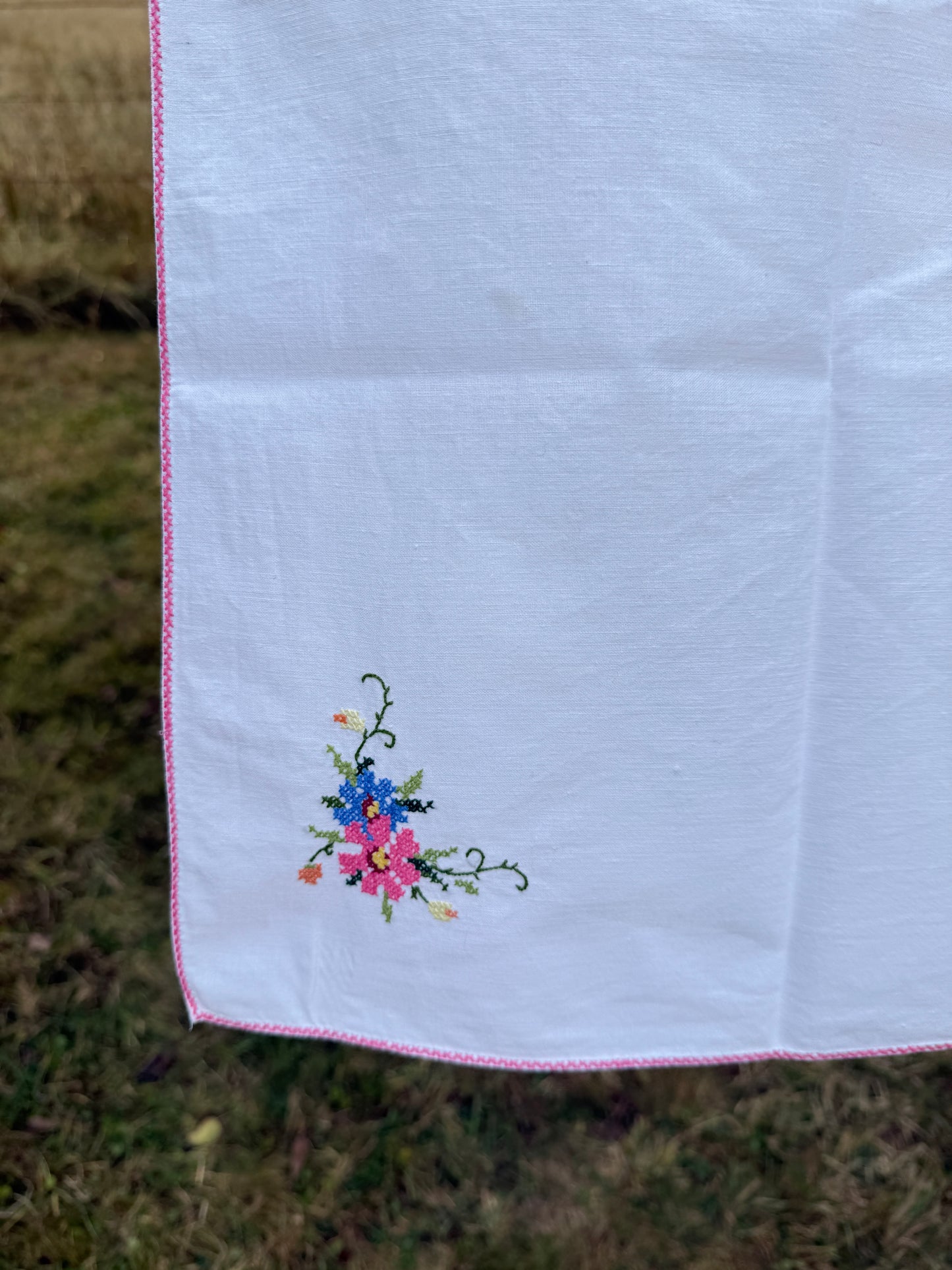 AA. white multi colored cross stitch 32" x 32"