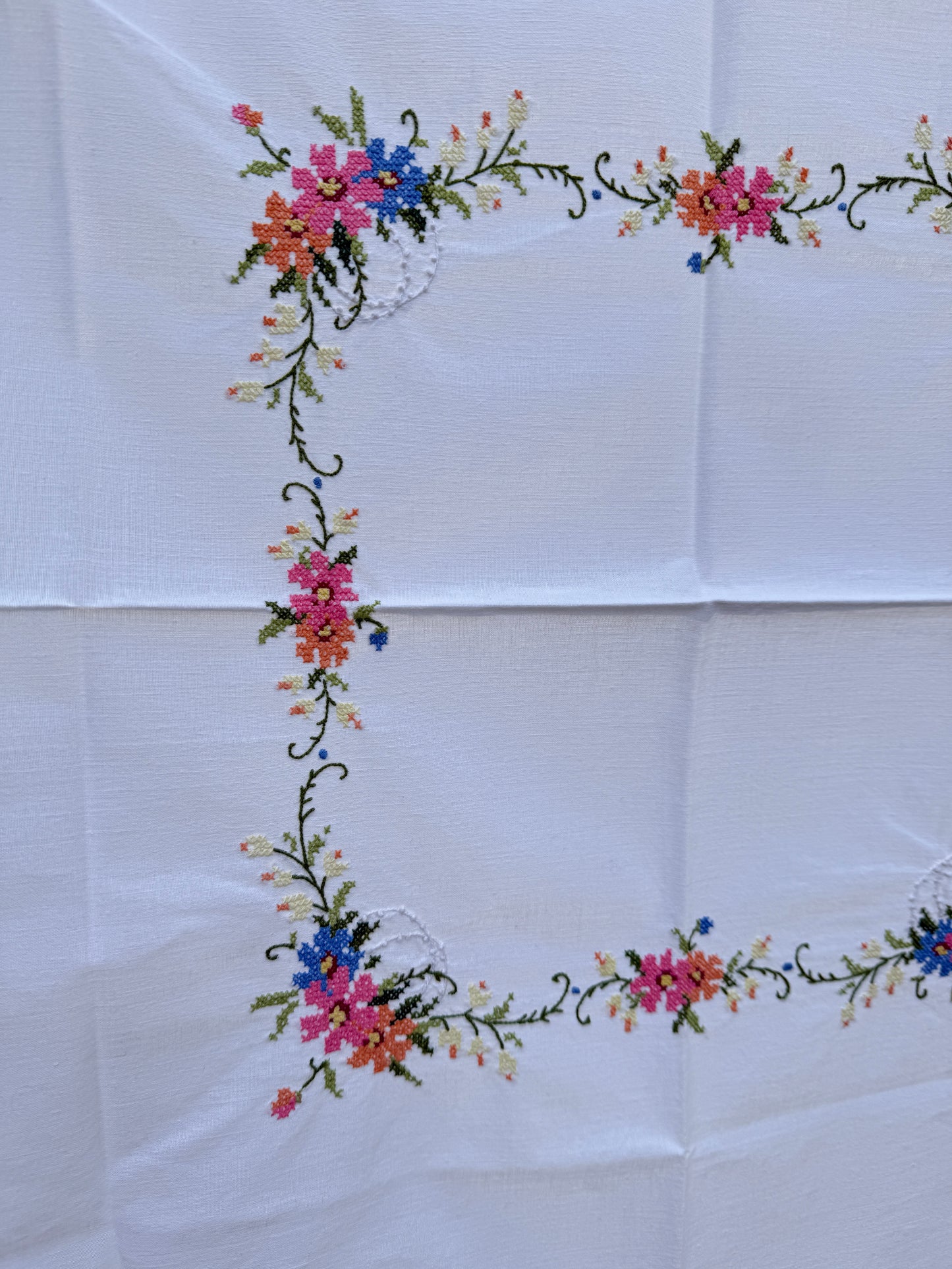 AA. white multi colored cross stitch 32" x 32"