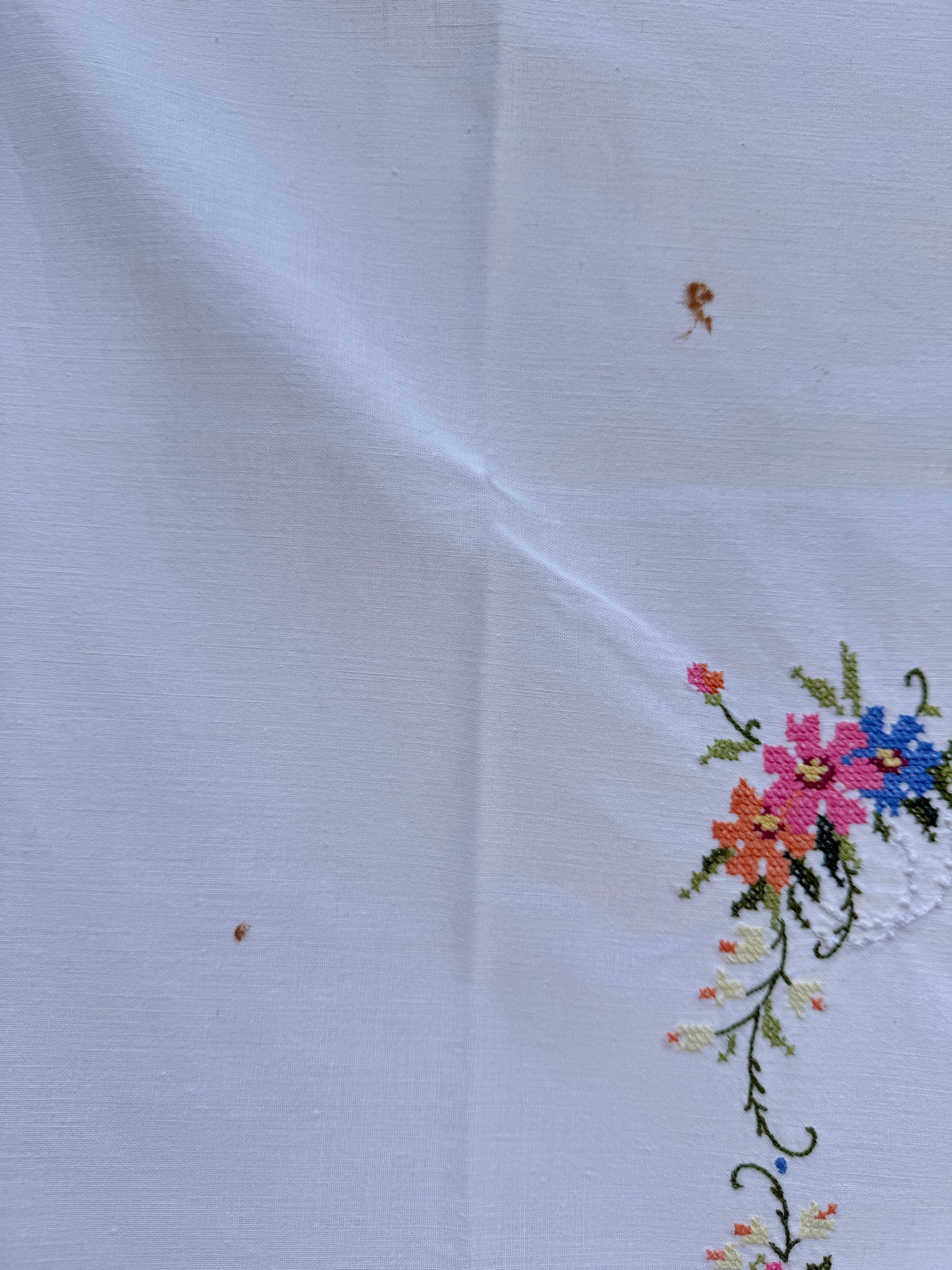 AA. white multi colored cross stitch 32" x 32"