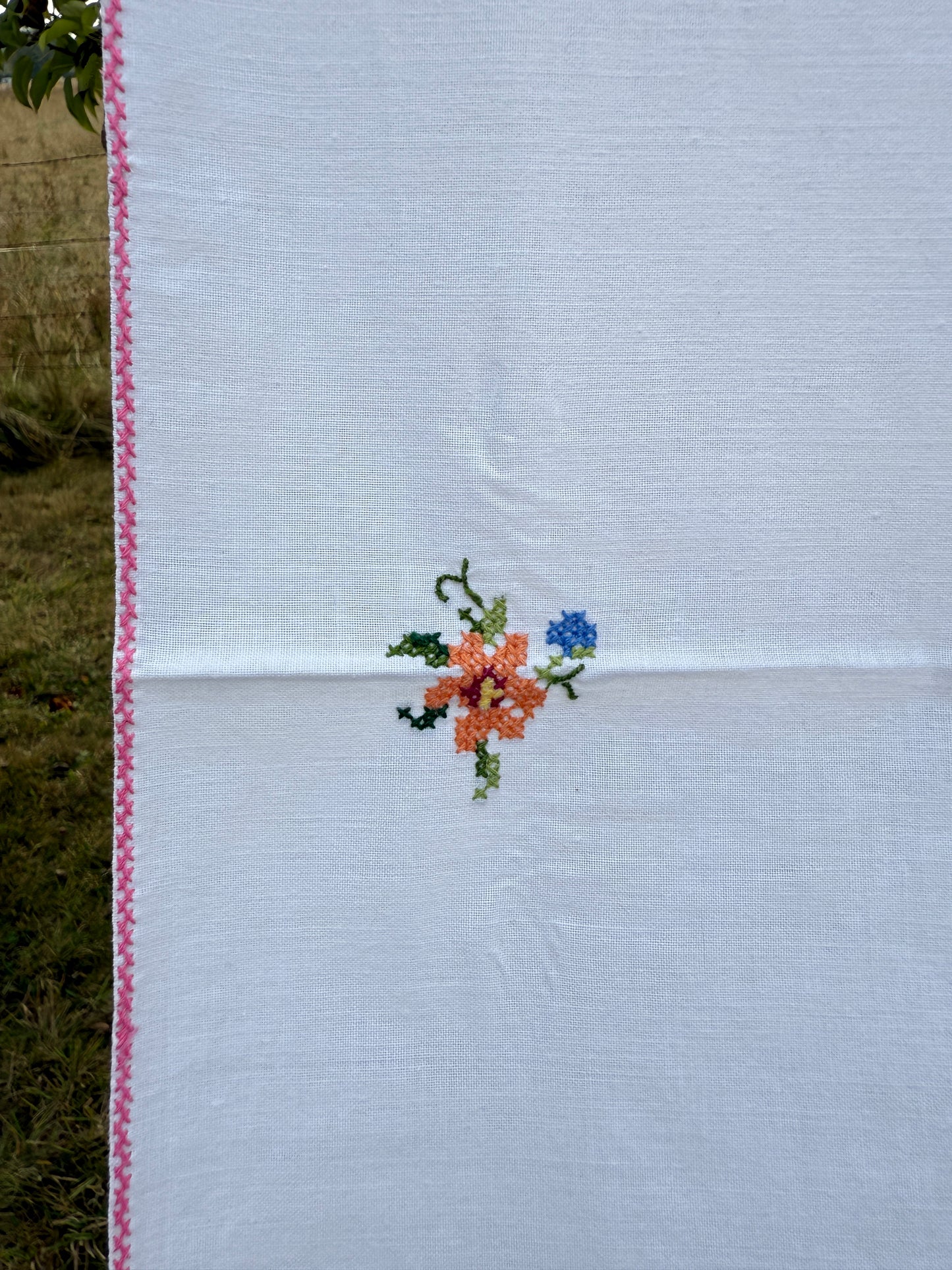 AA. white multi colored cross stitch 32" x 32"