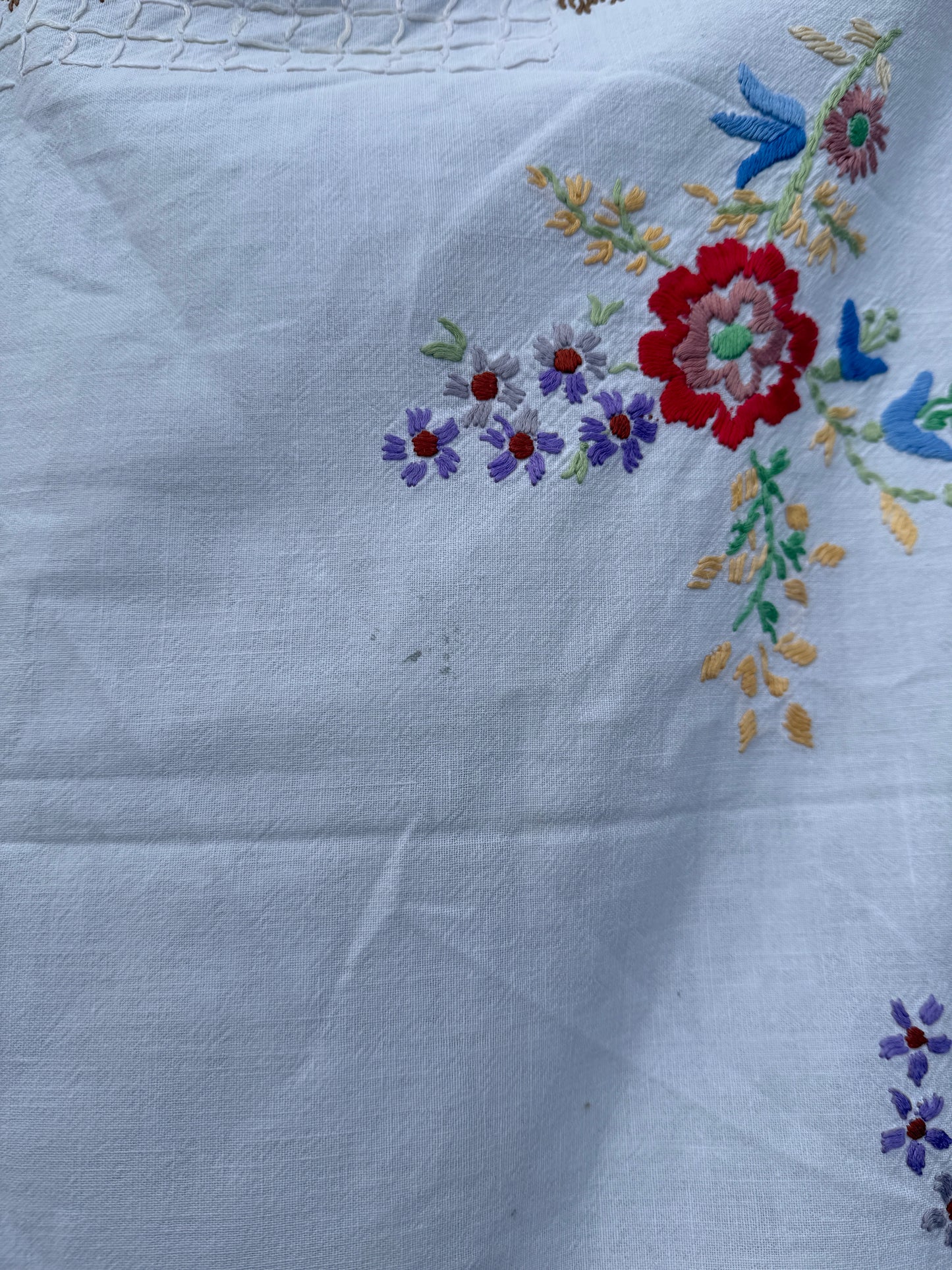 AA. Multi colored embroidered on soft canvas 45" x 52"