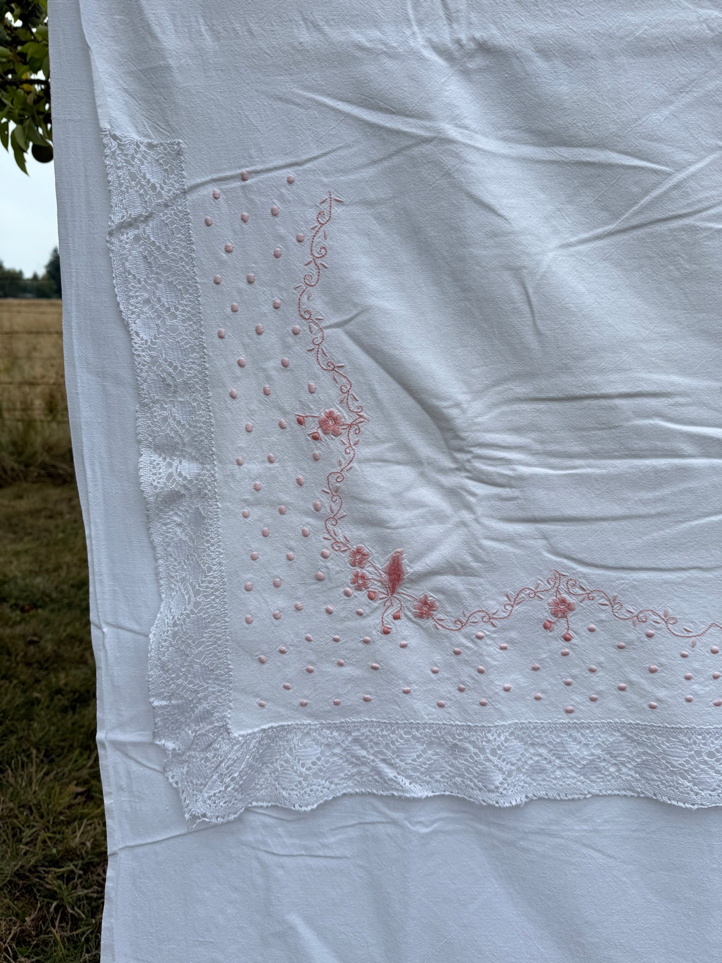 AA. Pink embroidered sheet with crochet trim 63" x 90"
