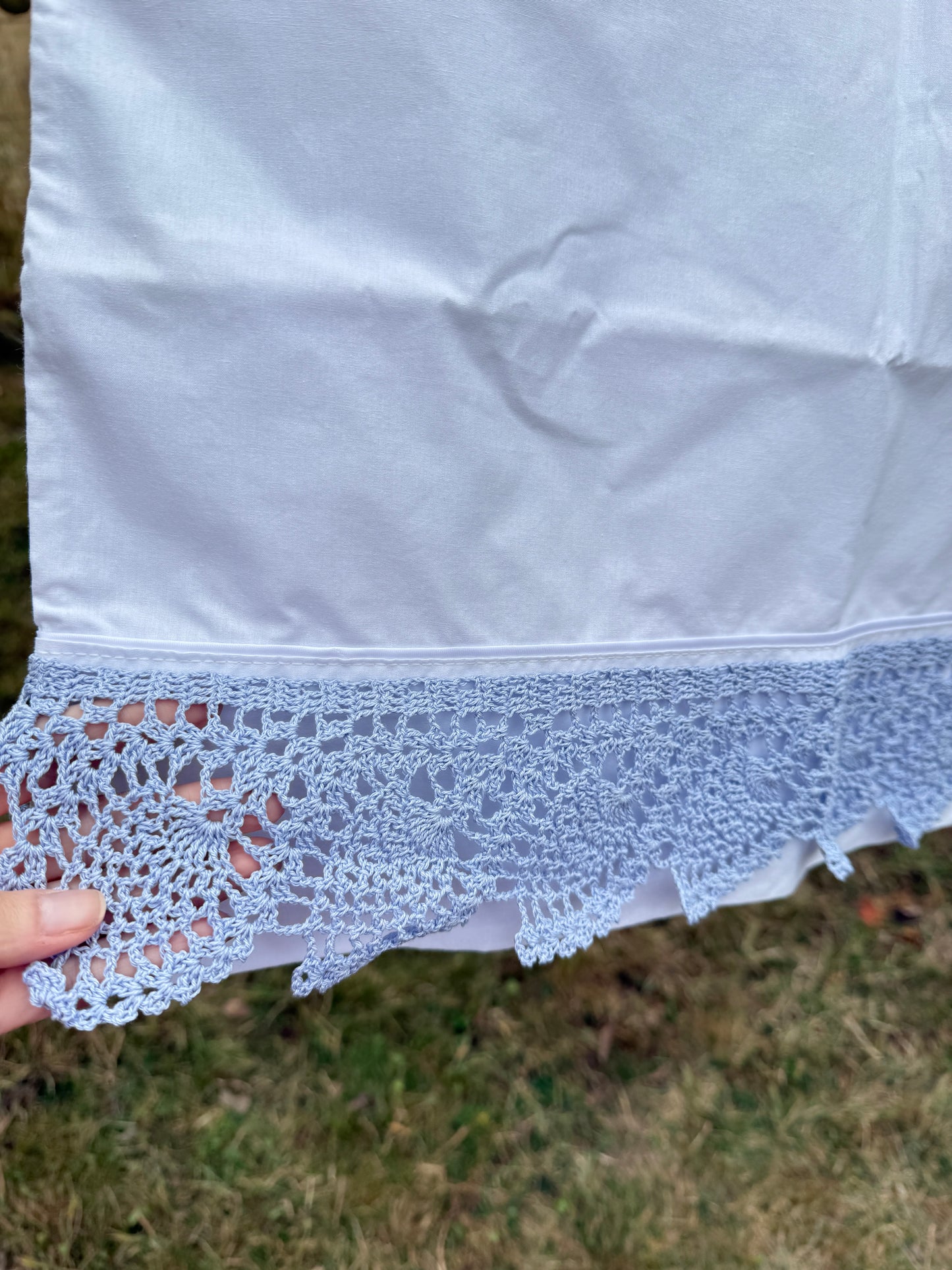 AA. Pair of pillowcases with blue crochet