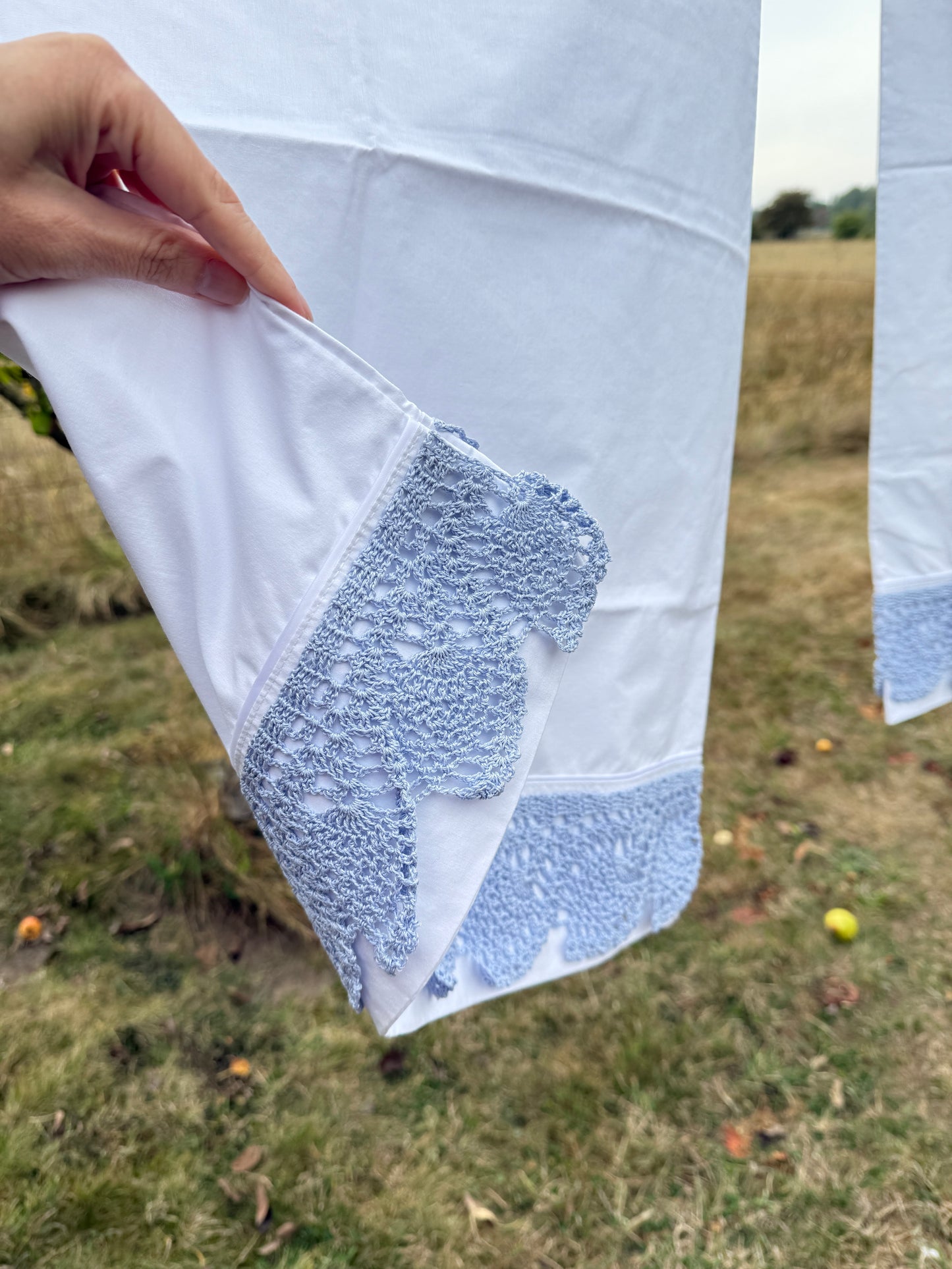 AA. Pair of pillowcases with blue crochet