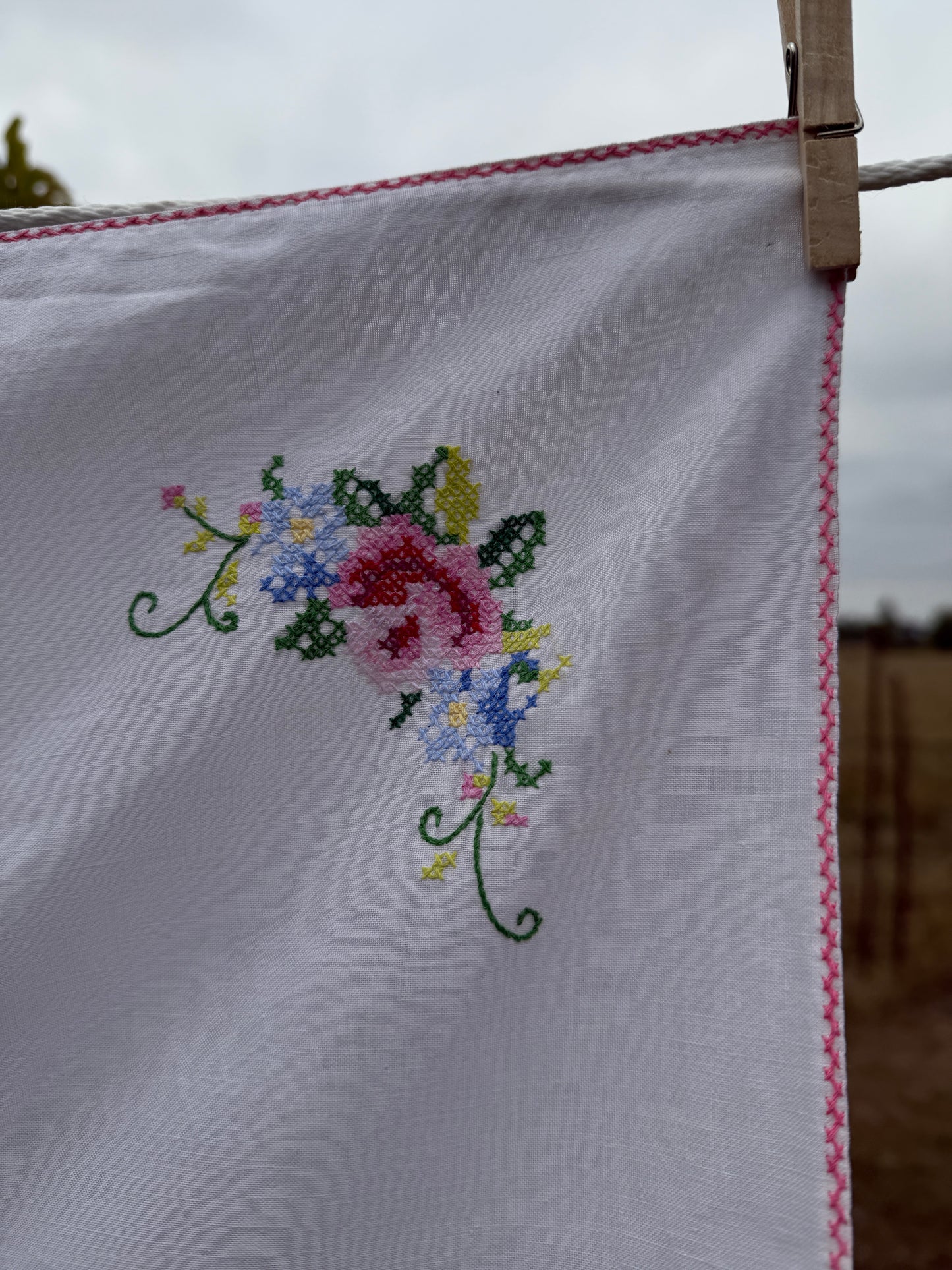 AA.Multi color cross stitch with pink edging 32" x 32"