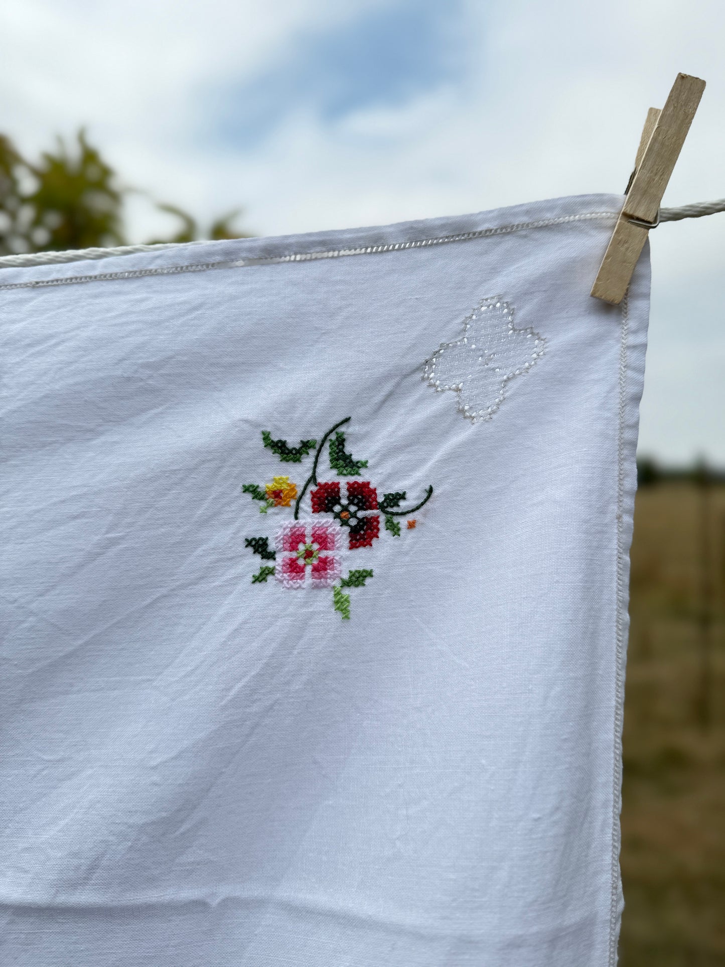 AA.Multi color cross stitch with tan entredeux edging 32" x 32"