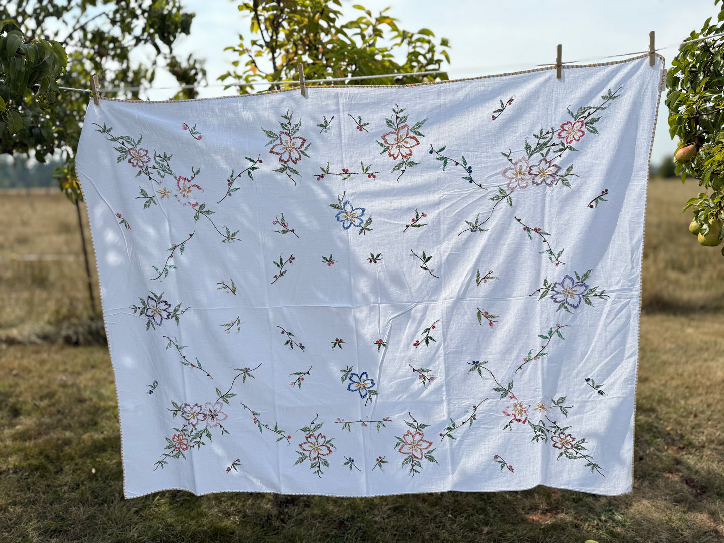 AA. multi colored flowers with yellow blanket stitch 58" x 44"