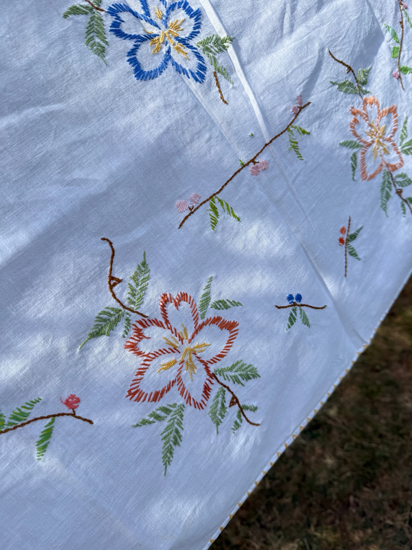 AA. multi colored flowers with yellow blanket stitch 58" x 44"