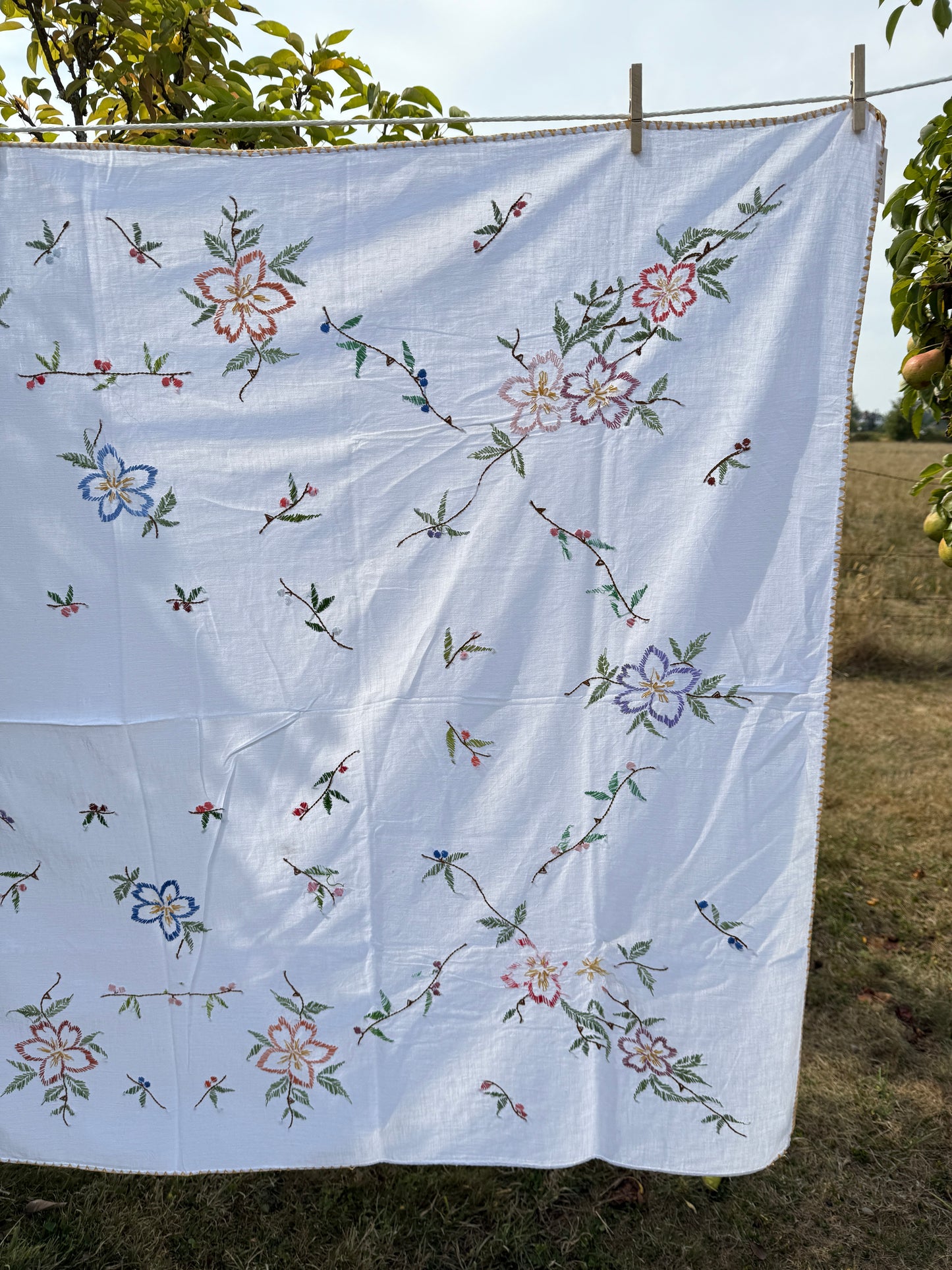 AA. multi colored flowers with yellow blanket stitch 58" x 44"