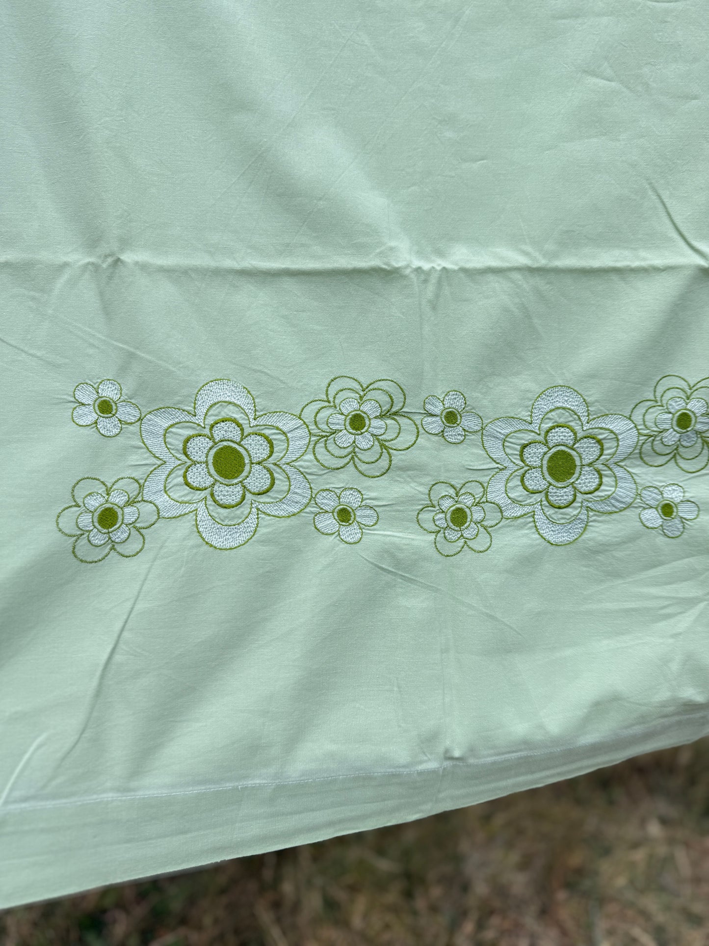 AA. Mint green sheet with daisy machine embroidery 55" x 97"