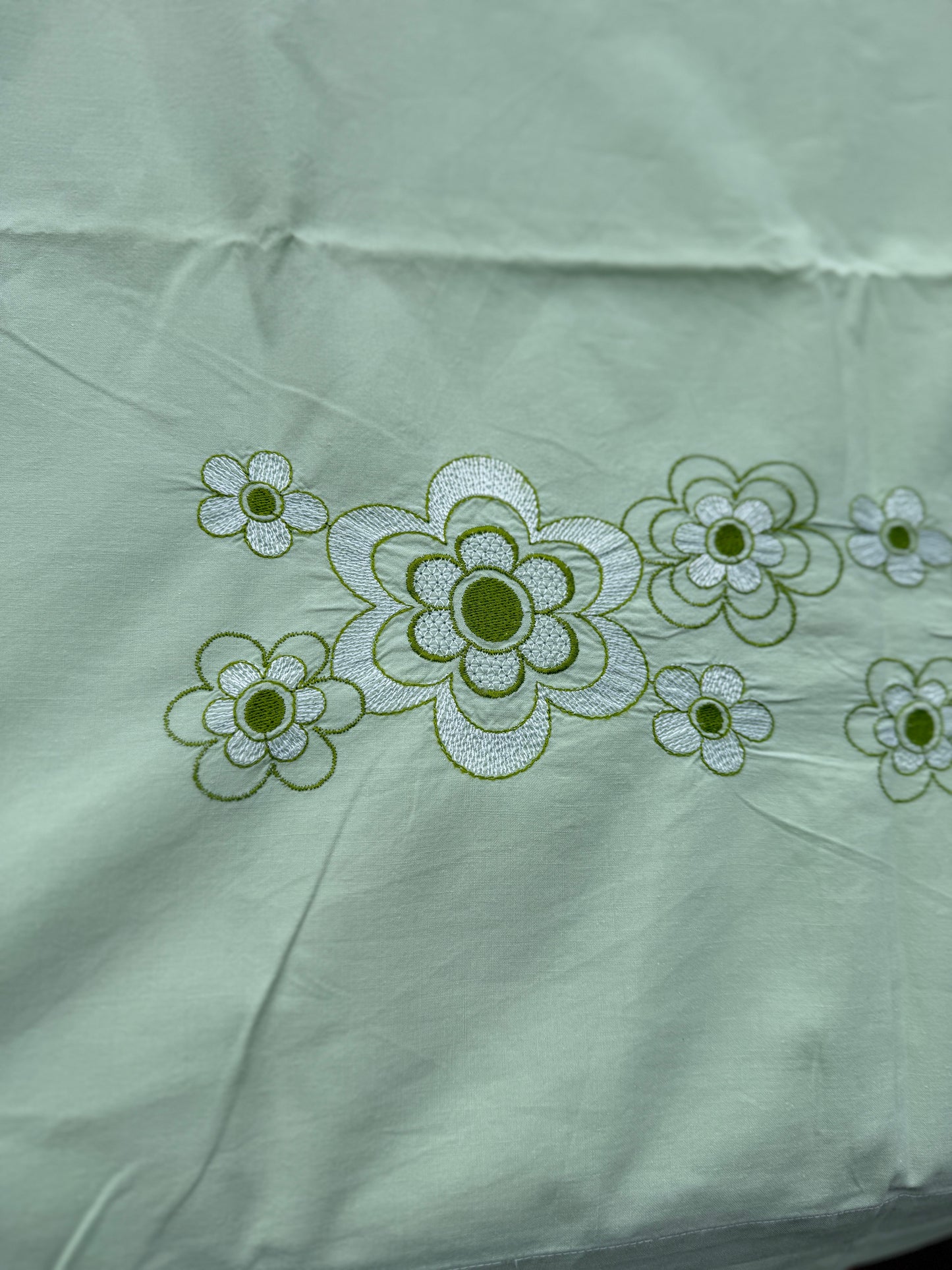 AA. Mint green sheet with daisy machine embroidery 55" x 97"