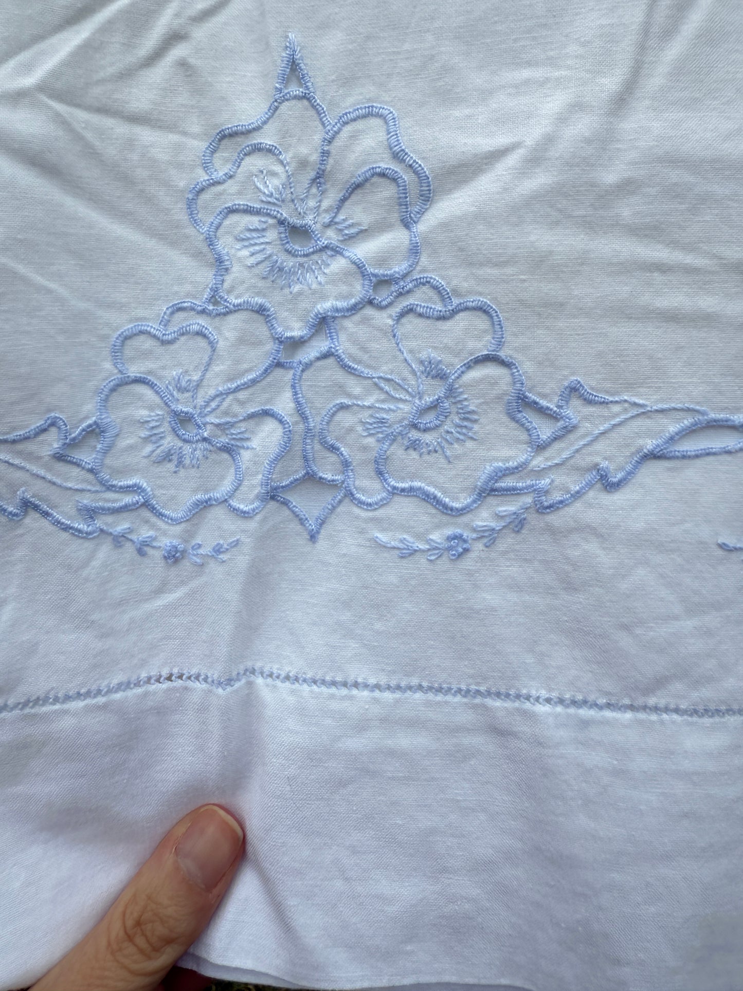 AA. Pair of white pillowcases with blue cut out embroidery